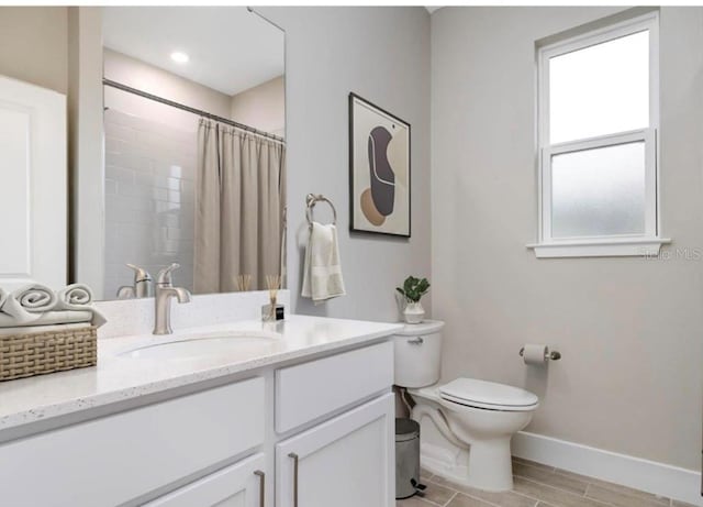 bathroom with toilet, walk in shower, and vanity