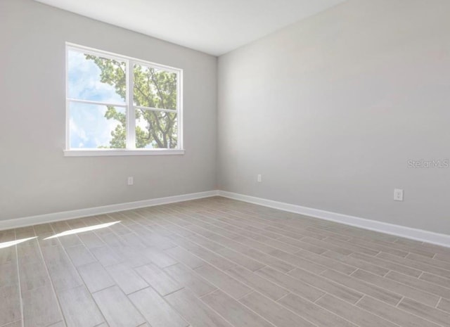 spare room with light hardwood / wood-style flooring