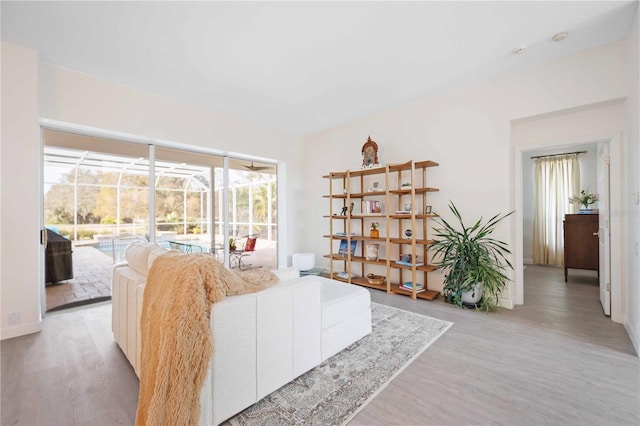 living area featuring light wood-type flooring and a sunroom