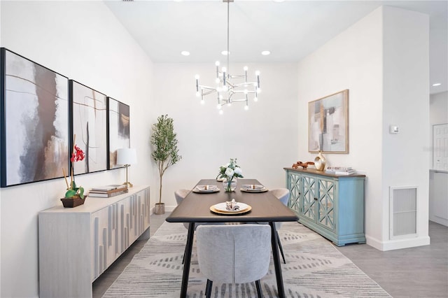 dining area featuring baseboards, visible vents, wood finished floors, an inviting chandelier, and recessed lighting