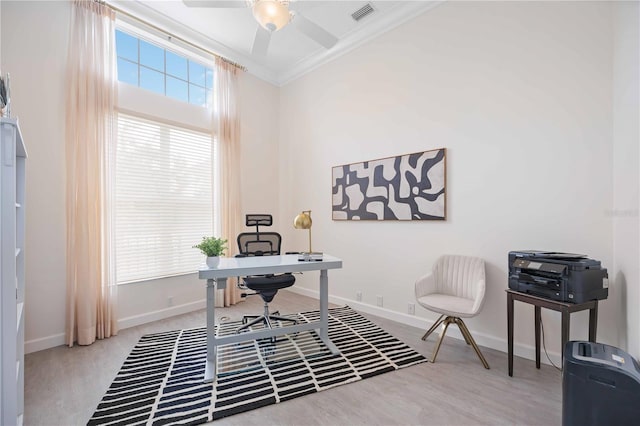 home office featuring ceiling fan, wood finished floors, visible vents, baseboards, and crown molding