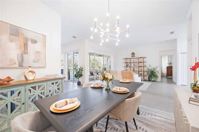 dining space featuring a chandelier and visible vents