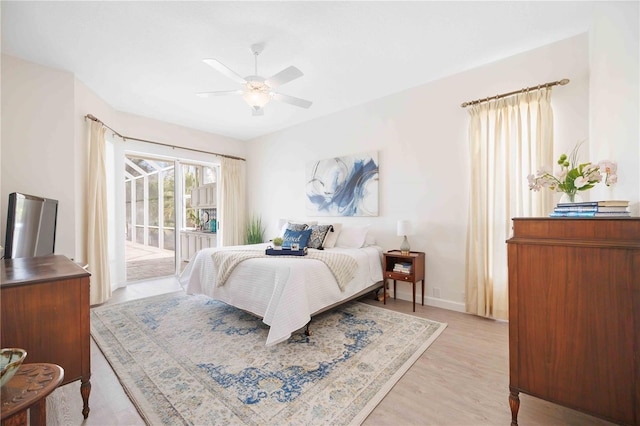 bedroom featuring light wood-type flooring, access to outside, ceiling fan, and baseboards