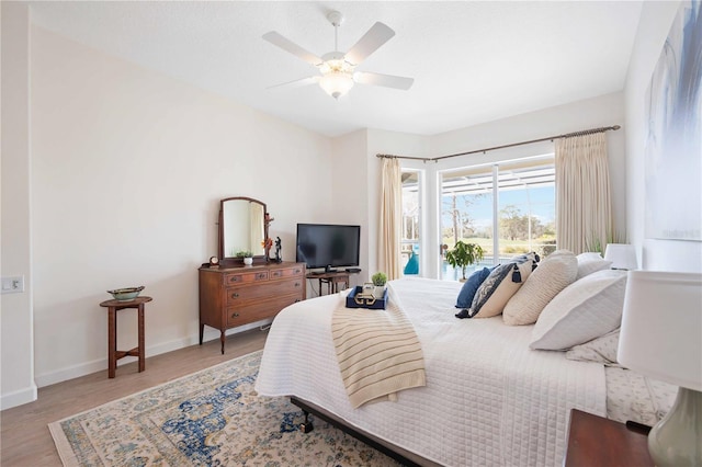 bedroom with ceiling fan and light hardwood / wood-style flooring