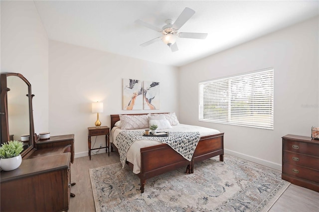 bedroom with a ceiling fan and baseboards