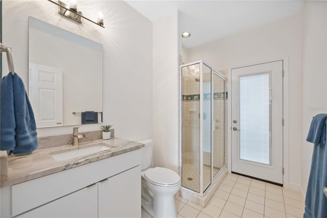 bathroom with vanity, tile patterned floors, toilet, and walk in shower