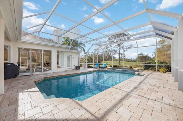 view of swimming pool with area for grilling, a lanai, a patio, and an in ground hot tub