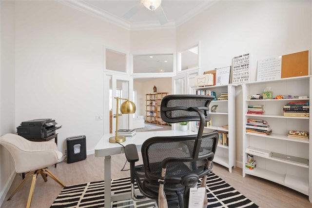 home office featuring a ceiling fan, crown molding, and wood finished floors