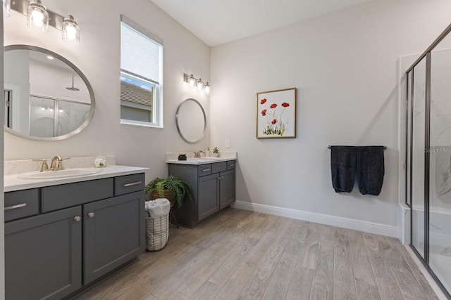 bathroom featuring vanity, hardwood / wood-style floors, and a shower with door