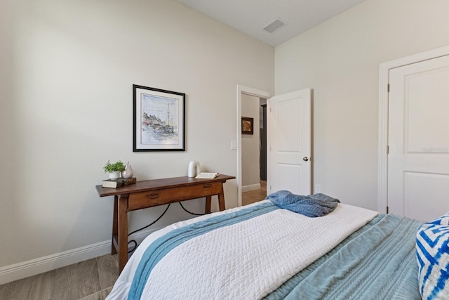 bedroom with hardwood / wood-style floors