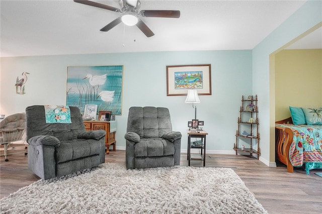 sitting room featuring ceiling fan and hardwood / wood-style floors