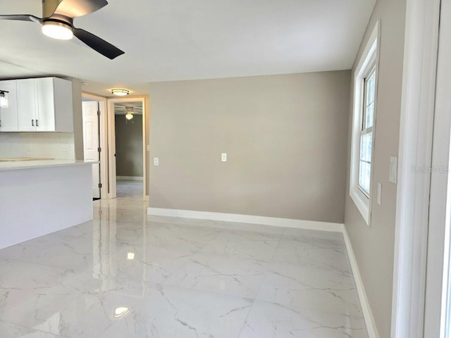 spare room with ceiling fan and a healthy amount of sunlight