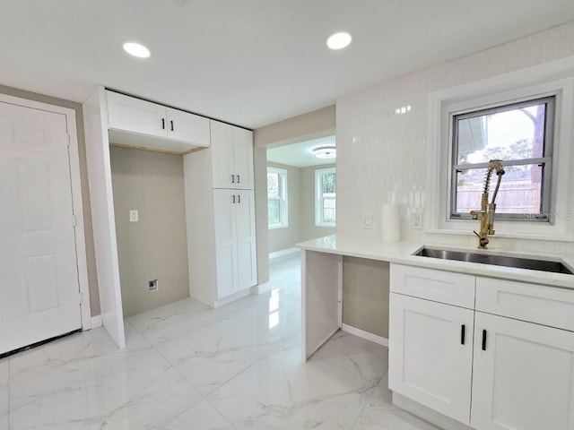 kitchen featuring sink and white cabinetry