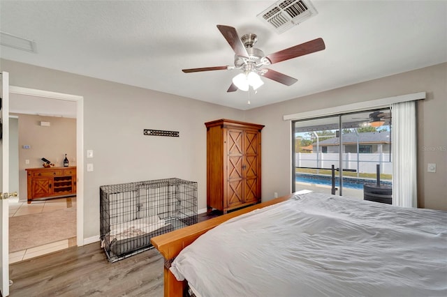 bedroom featuring ceiling fan, wood-type flooring, and access to exterior