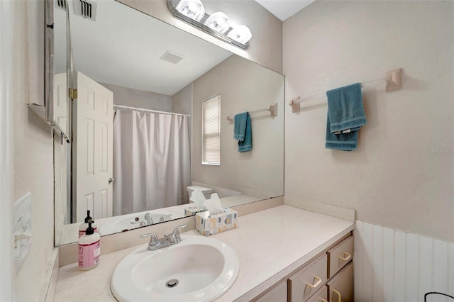 bathroom featuring vanity and a shower with shower curtain