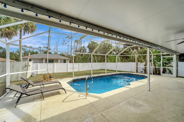 view of swimming pool with a patio area and glass enclosure