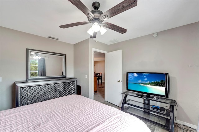 bedroom with ceiling fan, visible vents, and baseboards