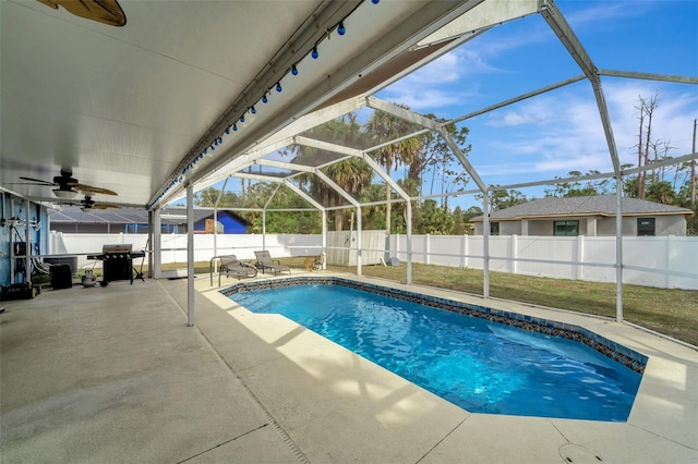 view of swimming pool featuring glass enclosure, a fenced backyard, area for grilling, a fenced in pool, and a patio area