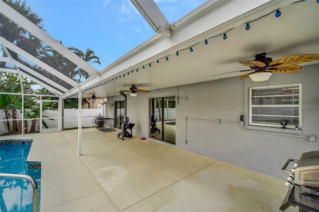 view of patio with glass enclosure, a fenced in pool, fence, and a ceiling fan