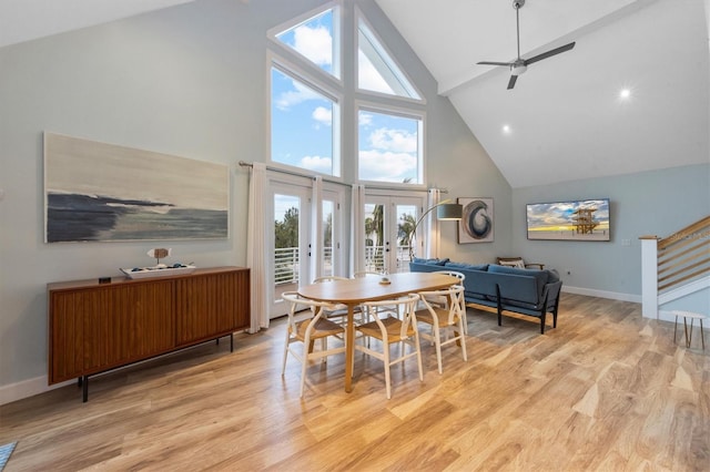 dining area featuring high vaulted ceiling, light hardwood / wood-style floors, ceiling fan, and french doors