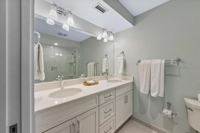 bathroom featuring an enclosed shower, vanity, tile patterned floors, and toilet