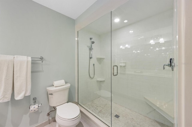 bathroom featuring toilet and an enclosed shower