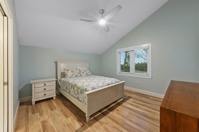 bedroom with ceiling fan, vaulted ceiling, and light hardwood / wood-style floors