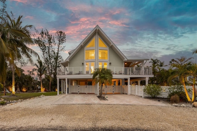 coastal inspired home with a carport and a balcony