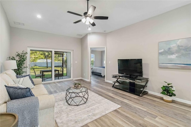 living room with wood-type flooring and ceiling fan