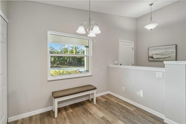 dining area featuring hardwood / wood-style flooring and a notable chandelier