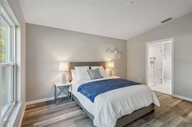 bedroom featuring wood-type flooring and vaulted ceiling