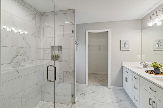 bathroom featuring an enclosed shower and vanity