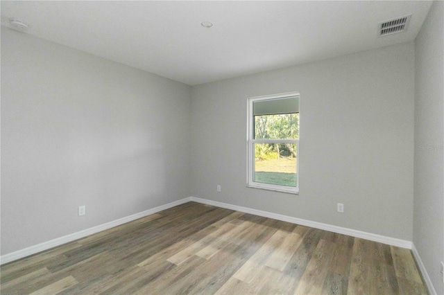 spare room featuring wood-type flooring