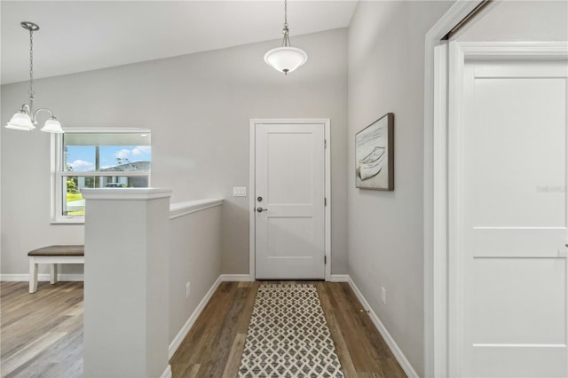 doorway featuring hardwood / wood-style flooring and an inviting chandelier