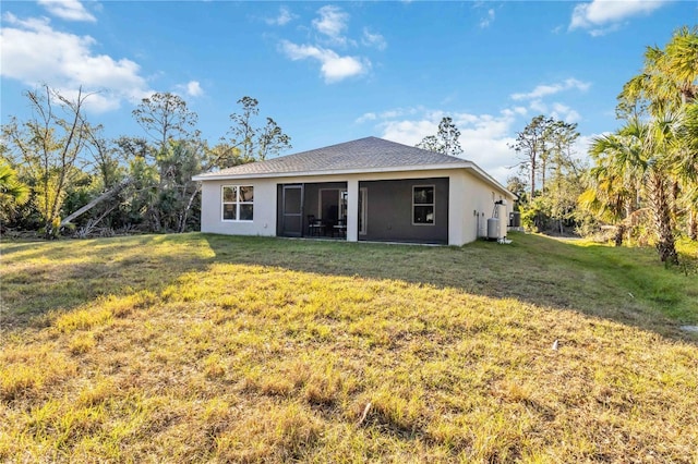 back of house with a lawn