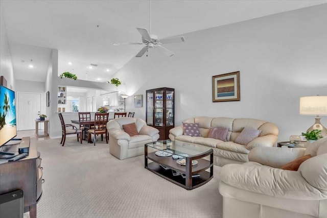 living room featuring light carpet, ceiling fan, and high vaulted ceiling