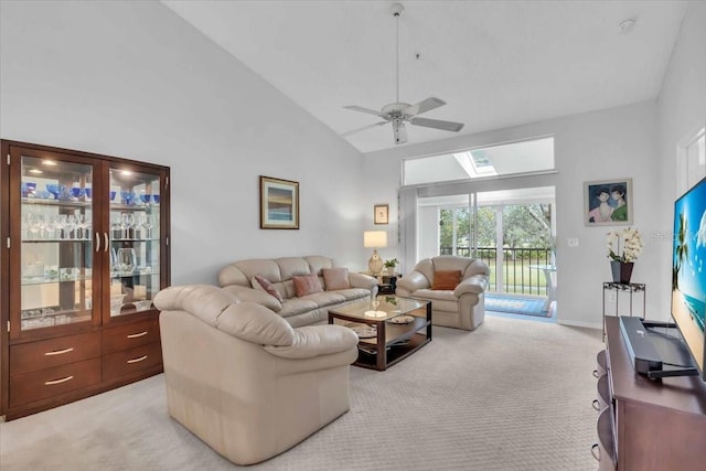 living room with ceiling fan, light colored carpet, and high vaulted ceiling