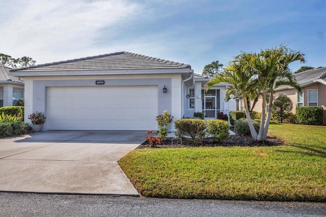 ranch-style house with a garage and a front yard