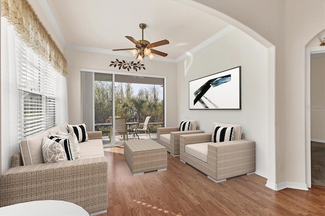 living room with crown molding, hardwood / wood-style floors, and ceiling fan