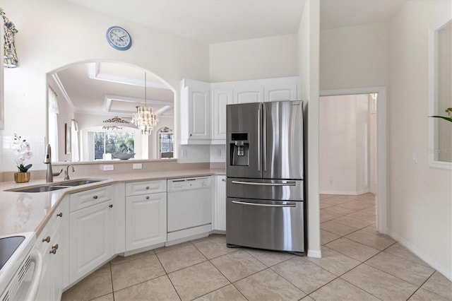 kitchen featuring stainless steel refrigerator with ice dispenser, decorative light fixtures, white cabinetry, sink, and white dishwasher