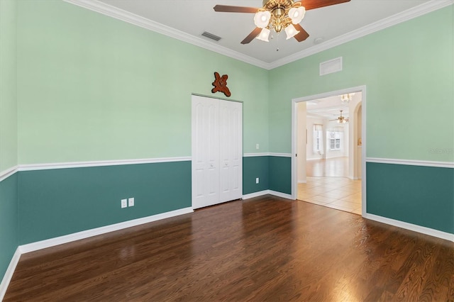 spare room featuring ceiling fan, crown molding, and dark hardwood / wood-style flooring