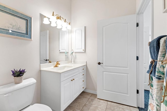 bathroom with toilet, tile patterned flooring, and vanity