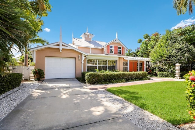 view of front of home with a garage and a front lawn