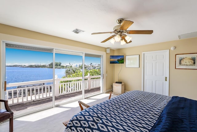 bedroom featuring ceiling fan, access to exterior, light colored carpet, and a water view