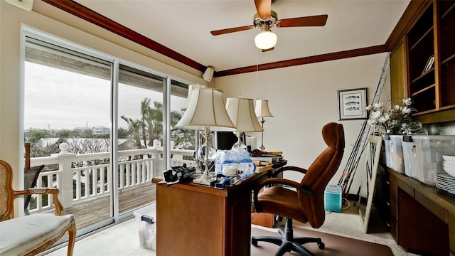 carpeted home office featuring ceiling fan and ornamental molding