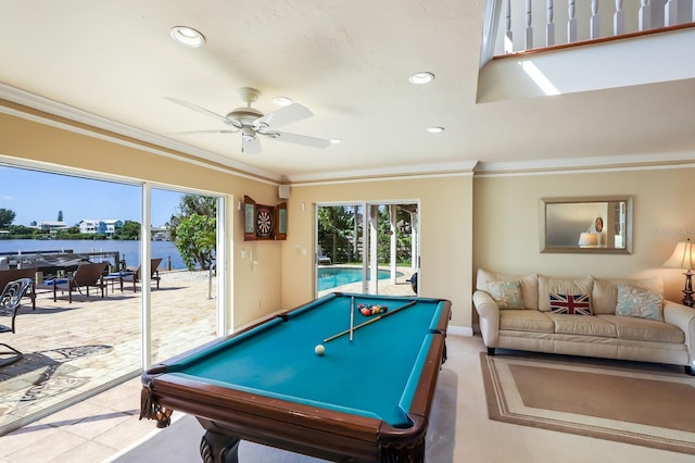 recreation room with a water view, ceiling fan, crown molding, and pool table