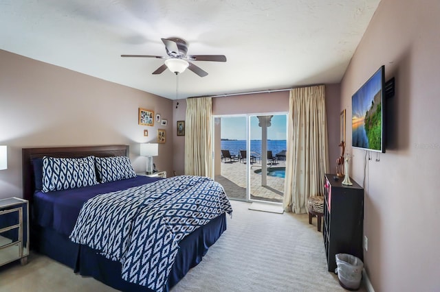 bedroom featuring ceiling fan, light colored carpet, and access to outside