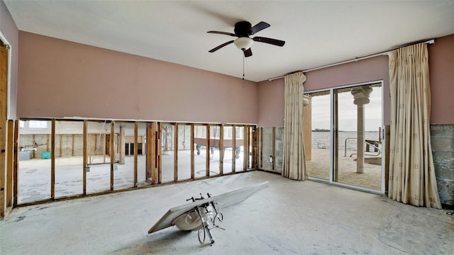 empty room featuring ceiling fan and a water view