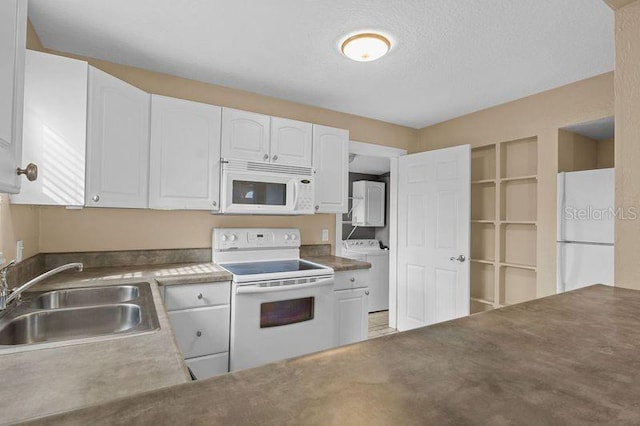 kitchen featuring white appliances, white cabinets, a textured ceiling, washer / clothes dryer, and sink