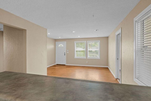 foyer featuring light hardwood / wood-style floors and a textured ceiling